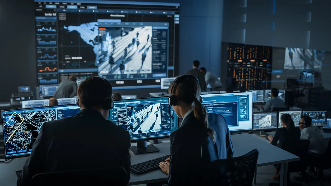 High-security operations centre with operators monitoring classified systems